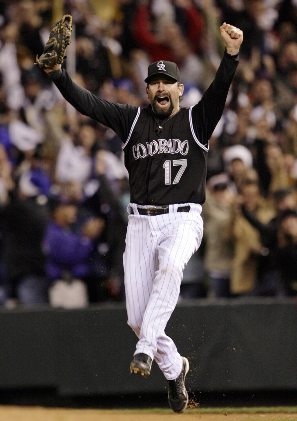 Retired Colorado Rockies first baseman Todd Helton throws out the