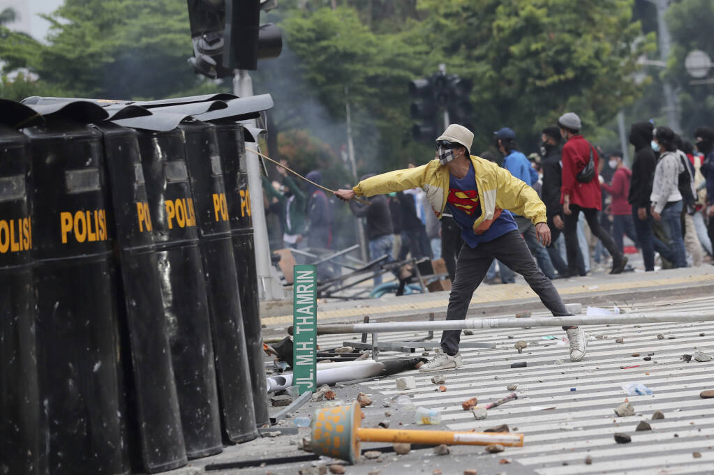 Protests against new labor law turn violent across Indonesia