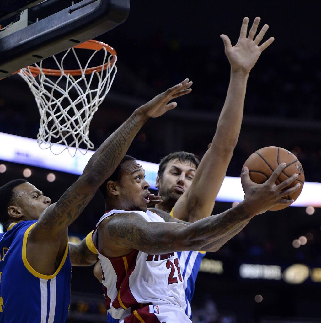 The Golden State Warriors' Brandon Rush (4), left, gets past the