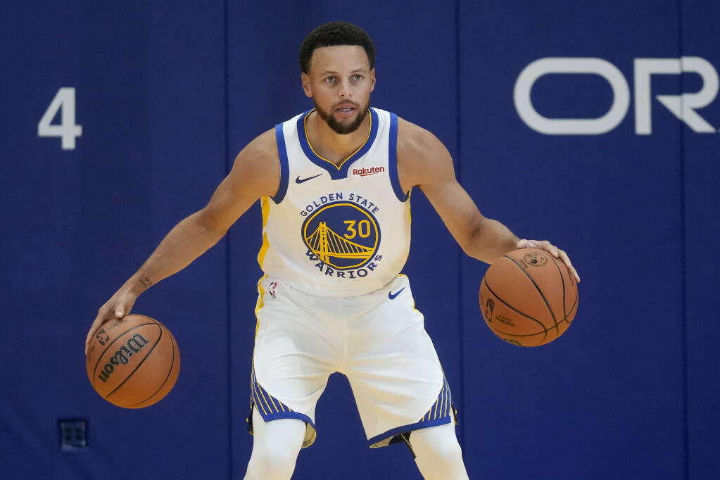 Golden State Warriors' Stephen Curry holds his All-Star game jersey
