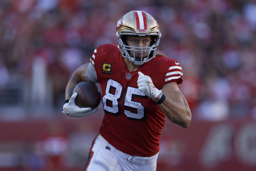 San Francisco 49ers' George Kittle (85) catches a pass in front of Kansas  City Chiefs' Daniel S …