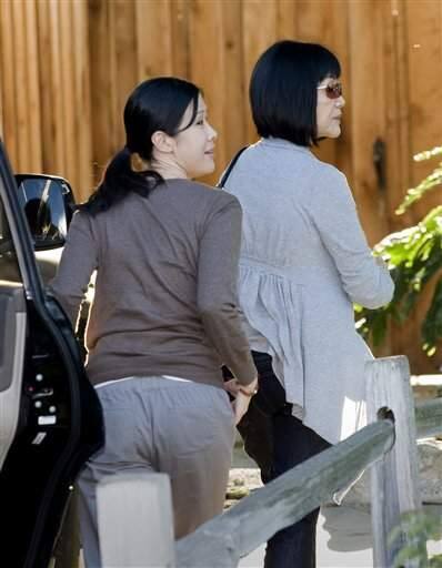Freed journalist Laura Ling's sister Lisa Ling, left, and husband Iain  Clayton, right, talk to the media at her home in the North Hollywood area  of Los Angeles, Wednesday, Aug. 5, 2009. (