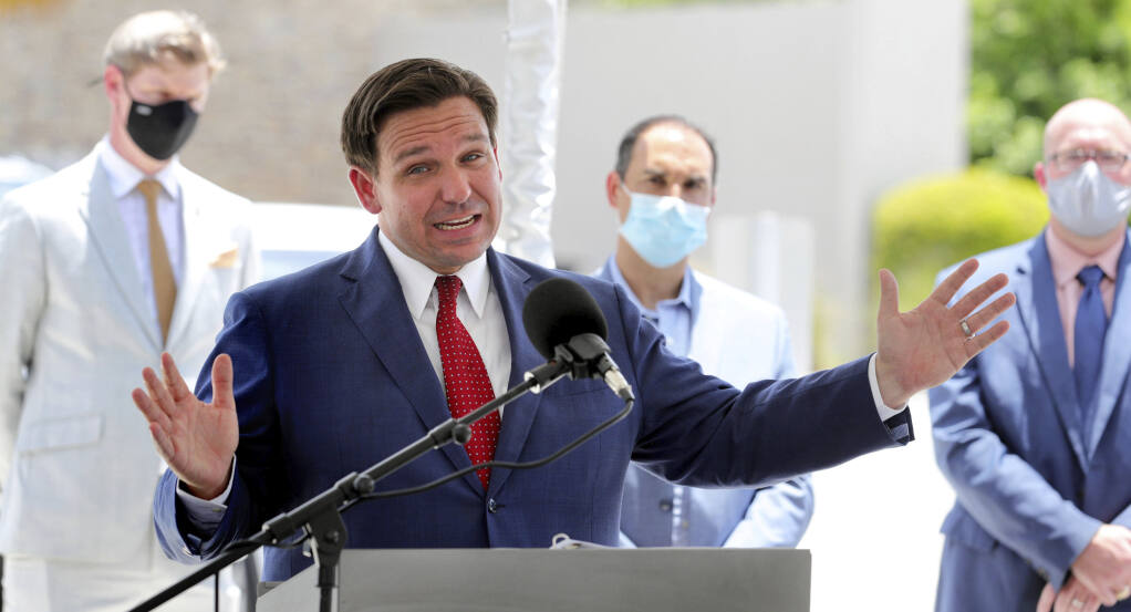 FILE - Florida Gov. Ron DeSantis gives an update on the state's response to the coronavirus pandemic during a press conference at Florida's Turnpike Turkey Lake Service Plaza, in Orlando, Fla., in a Friday, July 10, 2020 file photo. Florida on Sunday, July 13, 2020 reported the largest single-day increase in positive coronavirus cases in any one state since the beginning of the pandemic. (Joe Burbank/Orlando Sentinel via AP, File)