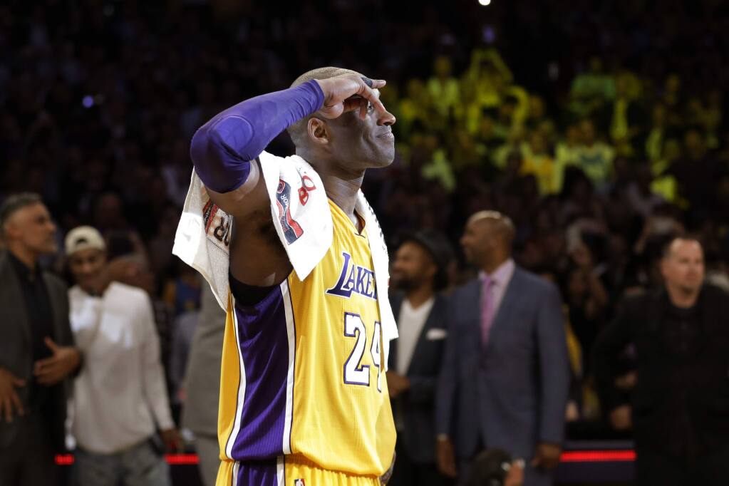 Kobe Bryant of the Los Angeles Lakers bites his jersey during a