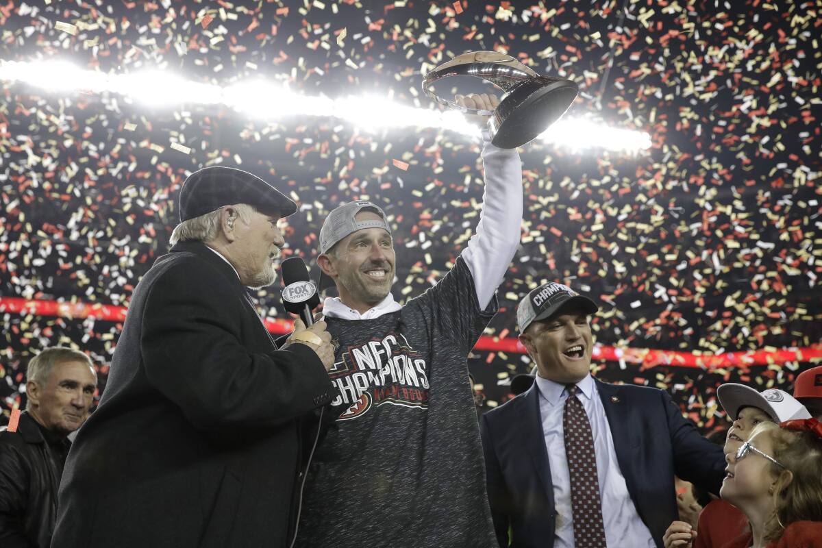 FOX broadcaster Terry Bradshaw presents the George Halas Trophy to San  Francisco 49er general manager John Lynch following the NFL football NFC  Championship game, Sunday, Jan. 19, 2020, in Santa Clara, Calif.