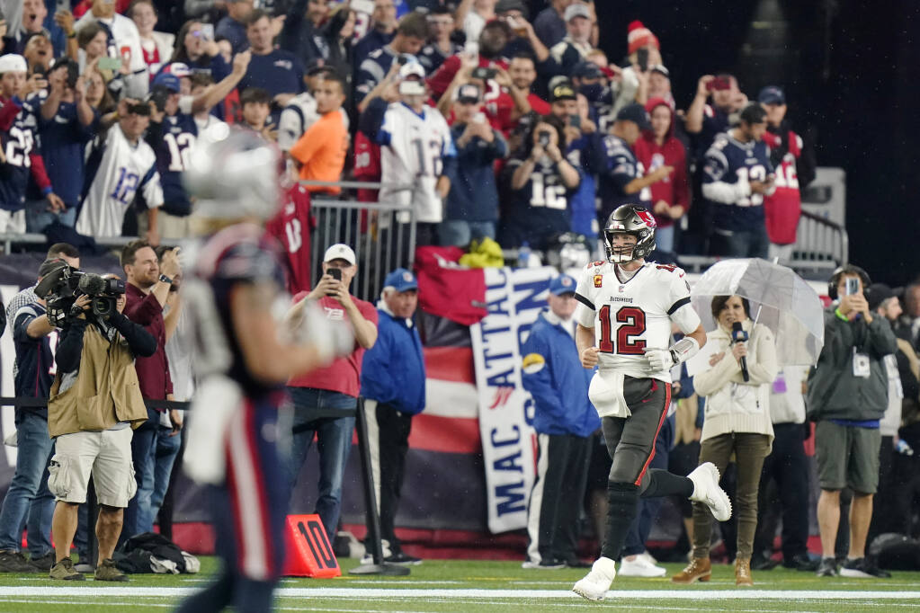 Bucs' Tom Brady gets win, passing yards record in return to New