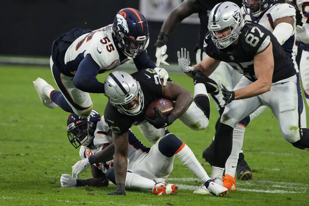 DENVER, CO - DECEMBER 18: Denver Broncos cornerback Pat Surtain II (2) goes  up to grab an interception during an NFL game between the Arizona Cardinals  and the Denver Broncos on December