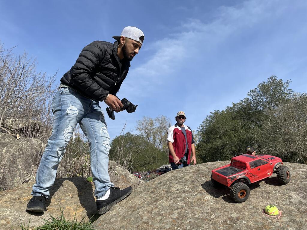 Beto Mendoza drives his remote control car through an obstacle course set up at Flat Rock Park in Santa Rosa on Sunday, Nov. 14, 2021. (Kerry Benefield/The Press Democrat)