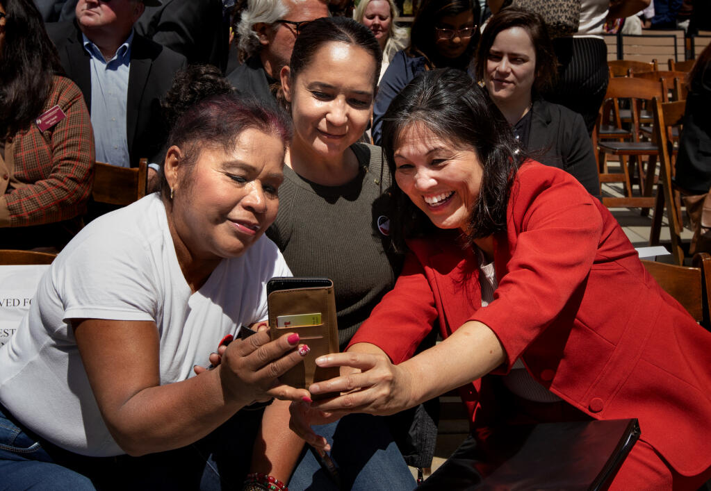 Acting U.S. Secretary of Labor Julie Su, right, poses with farmworkers, Daysi Estada Fuentes of Santa Rosa, who works for Balletto Vineyards, left, and Maria Castillas of Delano, Calif., center, after Su announced a new labor department rule to ensure fair labor standards for the U.S. agricultural industry, at a press conference at Balletto Vineyards in Santa Rosa, Friday, April 26, 2024. (Darryl Bush / For The Press Democrat)