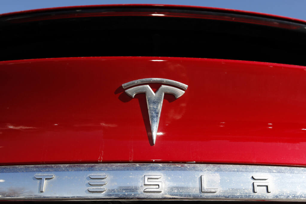 FILE - The Tesla company logo is shown at a Tesla dealership in Littleton, Colo., Feb. 2, 2020. A fatal July 2023 crash in California involving a Tesla has drawn the attention of federal investigators, who sent a team to the site of the site of what appears to have been a head-on crash. (AP Photo/David Zalubowski, File)