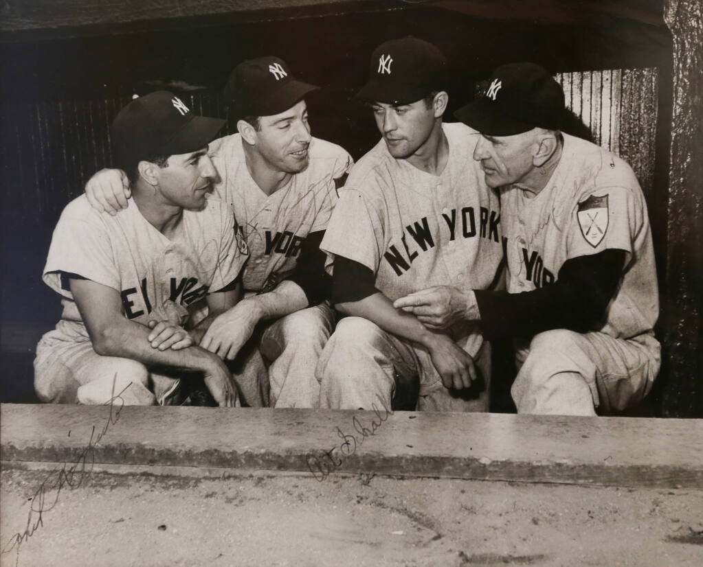 A photo of New York Yankees teammates Phil Rizzuto, left, Joe DiMaggio, Art Schallock, and manager Casey Stengel hangs in Art Schallock’s home in Sonoma, Friday, Feb. 17, 2023. (Christopher Chung / The Press Democrat)