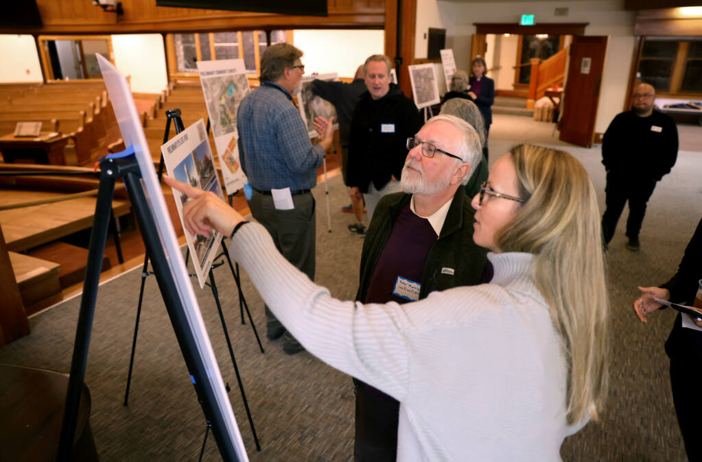 Burbank Housing project manager Karen Massey talks with Peter Morris during an open house at Napa First United Methodist Church about the preliminary designs of a mixed-use workforce housing project in Napa, Monday, Nov. 13, 2023. The project is a partnerships between Napa First United Methodist Church, Burbank Housing and Napa Valley Community Housing. (Beth Schlanker / The Press Democrat)
