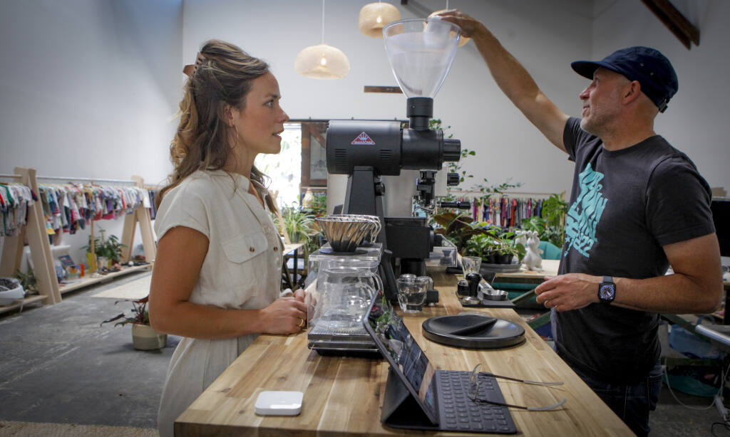 Laura Whelan, co-owner of NooNoo, orders a coffee from Kjeld Clark, who owns Súper Coffee Roasters and operates his café from inside NooNoo._ Monday, July 24, 2023._(CRISSY PASCUAL/ARGUS-COURIER STAFF)