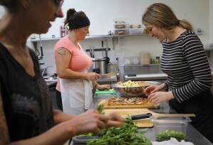 Naomi Crawford, Lindsey Paganini and Kaelyn Gage prepare meals at Lunchette in downtown Petaluma. The small eatery uses compostable containers to package the takeout salads. (CRISSY PASCUAL/ARGUS-COURIER STAFF)