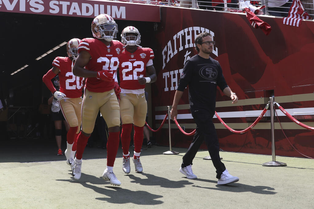 Then-49ers offensive coordinator Mike McDaniel, right, walks onto the field with players before a 2021 preseason game against the Las Vegas Raiders in Santa Clara. (Jed Jacobsohn / ASSOCIATED PRESS)