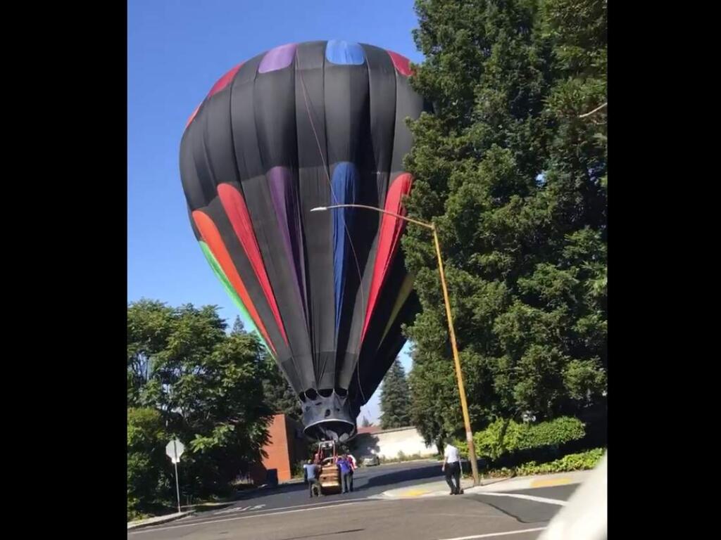 A hot air balloon made an emergency landing in the Sears Auto Center parking lot in downtown Santa Rosa, Thursday, June 29, 2017. (Lila Wetherwax)