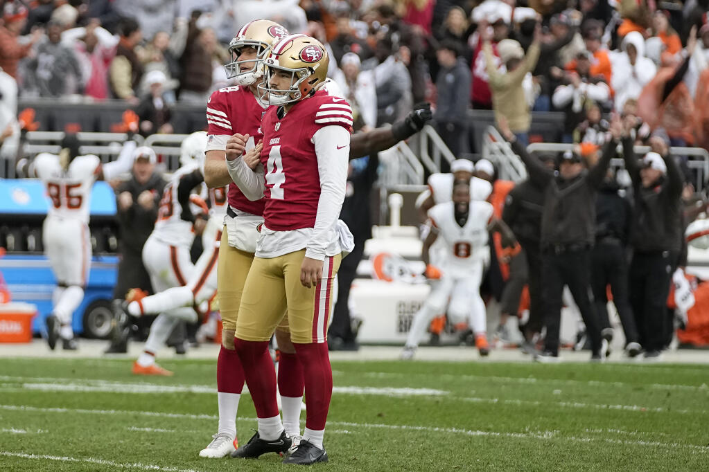 Cleveland Browns players and coaches celebrate, rear, as San Francisco 49ers place kicker Jake Moody (4) and Mitch Wishnowsky react after Moody missed a field goal during the second half of an NFL football game Sunday, Oct. 15, 2023, in Cleveland. (AP Photo/Sue Ogrocki)