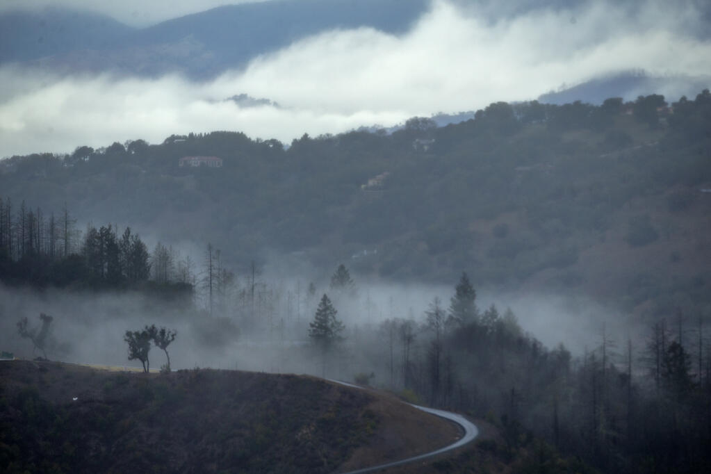 Low clouds and fog hang in the valley north of Santa Rosa near Riebli Road as seen off Skyfarm Drive in Fountaingrove, Thursday, Dec. 1, 2022. (Chad Surmick/The Press Democrat)