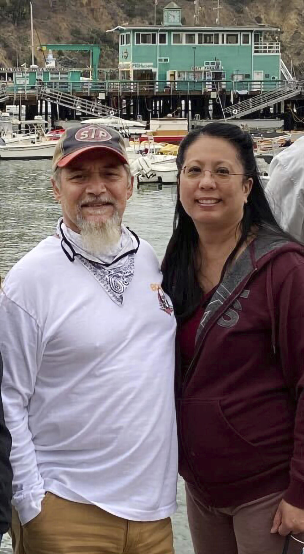 This undated photo provided by James Solis shows Robert Solis, left and his partner Brandi Tyau, right. Robert Solis and Tyau were aboard the charter fishing vessel Awakin when it ran into trouble Sunday in rough seas off the coast of southeast Alaska. The bodies of three of the five people aboard have been found but two people remain missing. Authorities are working to salvage the boat, which was found partially submerged off an island near Sitka, Alaska. Those on the vessel were Solis and Tyau, Tyau's sister and her partner and the boat captain. (James Solis via AP)
