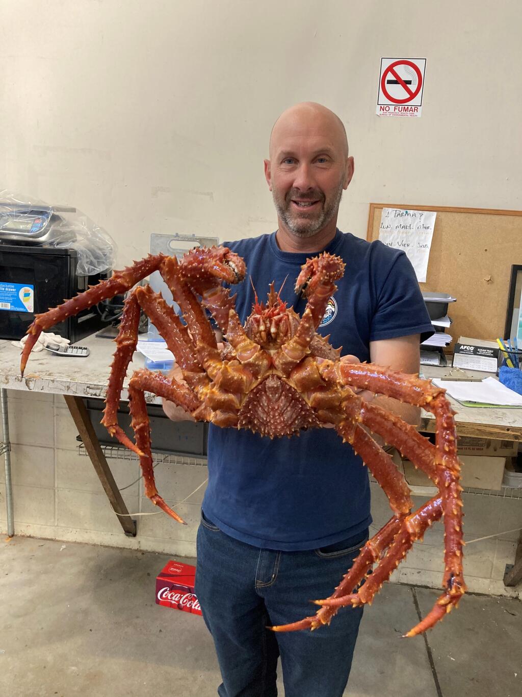 Brian Anderson, former Sonoma County restaurateur, in June holds a giant crab at San Francisco-based Costarella Seafoods, where he now works as a fish salesman. (courtesy of Brian Anderson)