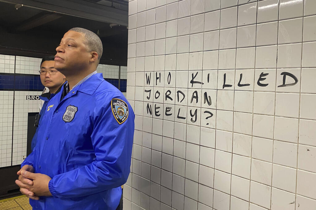 Police officers watch as protesters gather in the Broadway-Lafayette subway station to protest the death of Jordan Neely, Wednesday, May 3, 2023 in New York. Four people were arrested, police said. Neely, a man who was suffering an apparent mental health episode aboard a New York City subway, died this week after being placed in a headlock by a fellow rider on Monday, May 1, according to police officials and video of the encounter. (AP Photo/Jake Offenhartz)