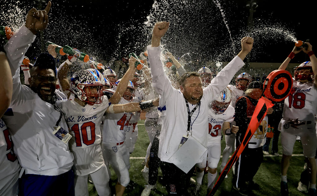 St. Vincent de Paul Mustangs head coach Trent Herzog and the rest of his team celebrates a 6-AA state football title in Pasadena after a win over Wasco High School, Friday, Dec. 8, 2023.  (Kent Porter / Press Democrat)
