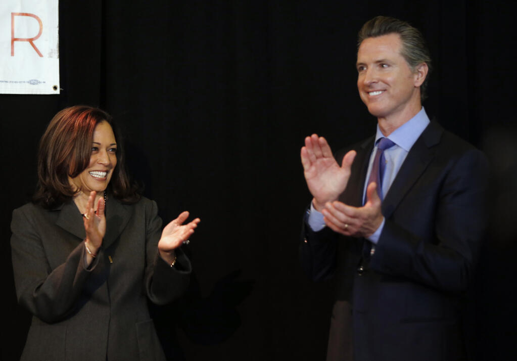 Sen. Kamala Harris, left, endorses Gavin Newsom for the 2018 California Governor's race at the Ronald Tutor Campus Center at the University of Southern California in Los Angeles on Friday, Feb. 16, 2018. (AP Photo/Damian Dovarganes)