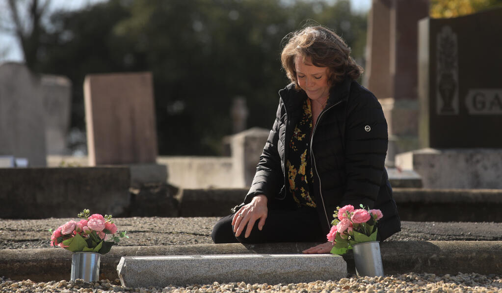 Madeleine Keegan O'Connell visits the graves of her mother and father, Vivian and Frank Keegan, Tuesday, March 16, 2021, in Santa Rosa. (Kent Porter / The Press Democrat)