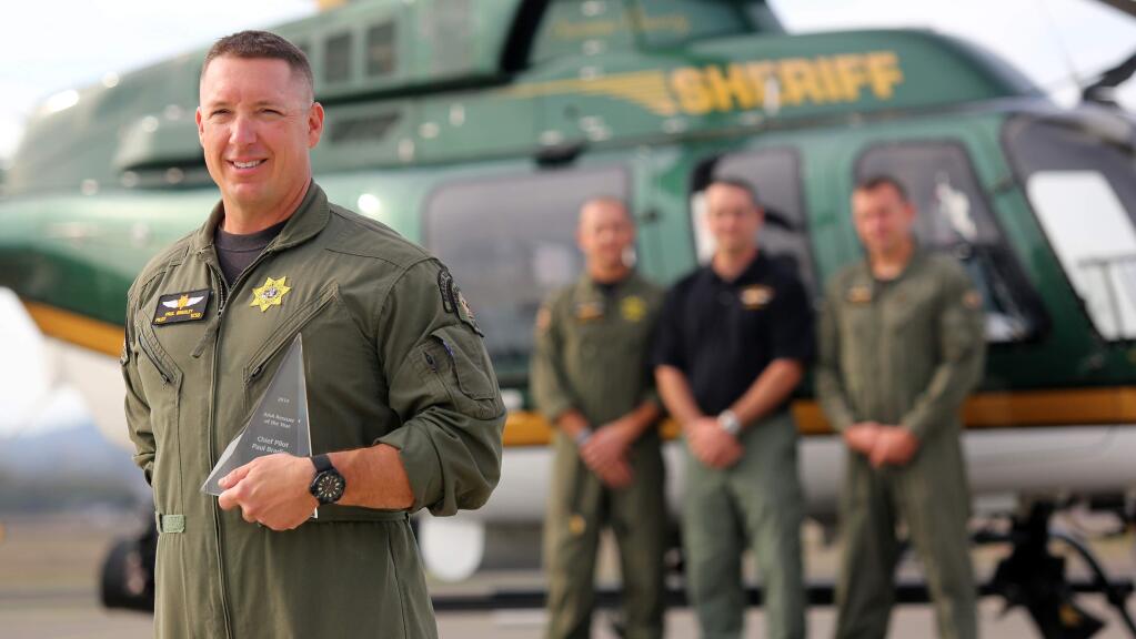 Sonoma County Sheriff Pilot Paul Bradley, left, received the AAA 'Rescuer of the Year' award for flying 200 miles to save a stranded group on a cliff near Crescent City, CA. (Crista Jeremiason / The Press Democrat)