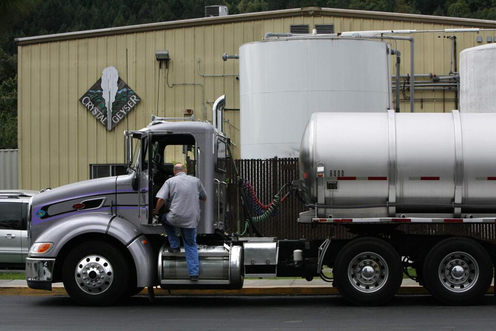 A truck parks in front of the Crystal Geyser building on Calistoga's Washington Street after pumping its load of water into the facility. August 9, 2009. (Press Democrat File)