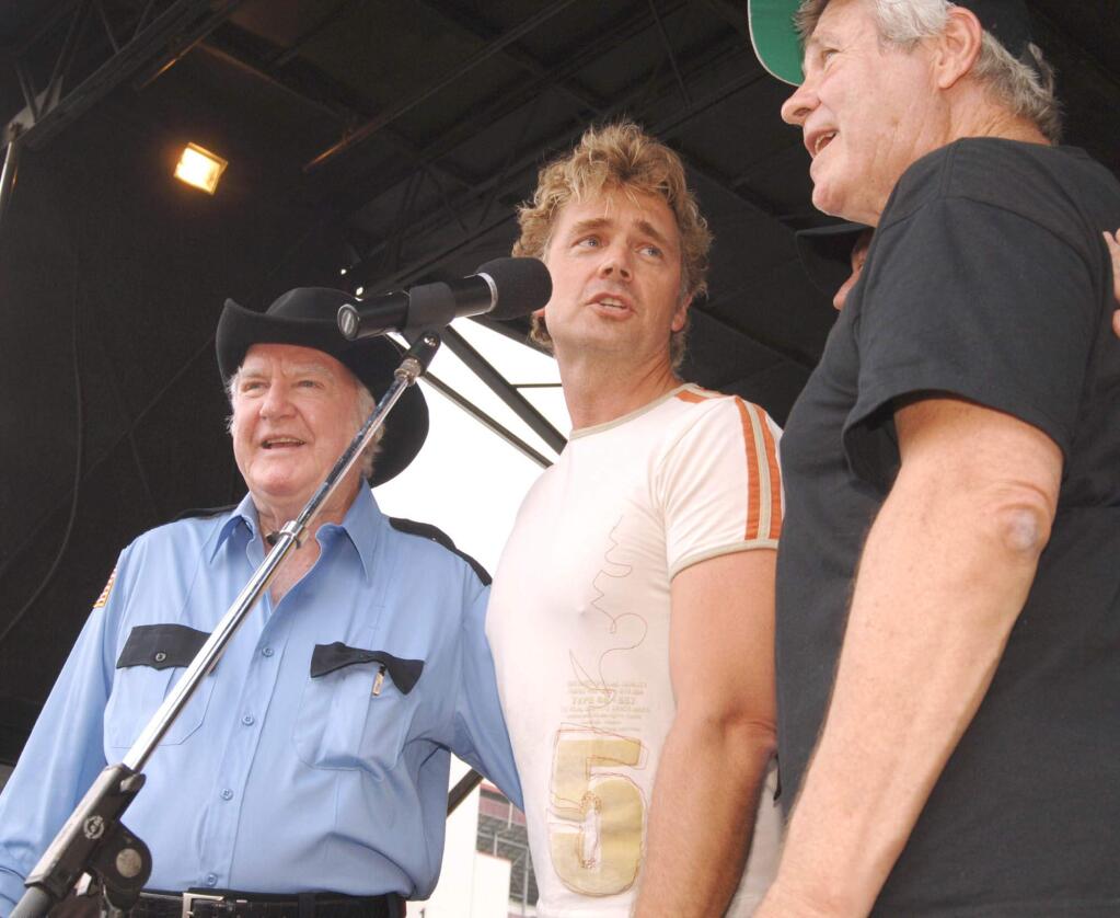 FILE - In this June 4, 2005 file photo, 'Dukes of Hazzard' cast members James Best, left, John Schneider, center, and Ben Jones, sing during the DukesFest 2005 at the Bristol Motor Speedway in Bristol, Tenn. Best, the prolific actor best known for his role as Sheriff Rosco P. Coltrane on 'The Dukes of Hazzard' died Monday, April 6, 2015, in hospice care in Hickory from complications of pneumonia. He was 88. (AP Photo/Bristol Herald Courier, Earl Neikirk, File)