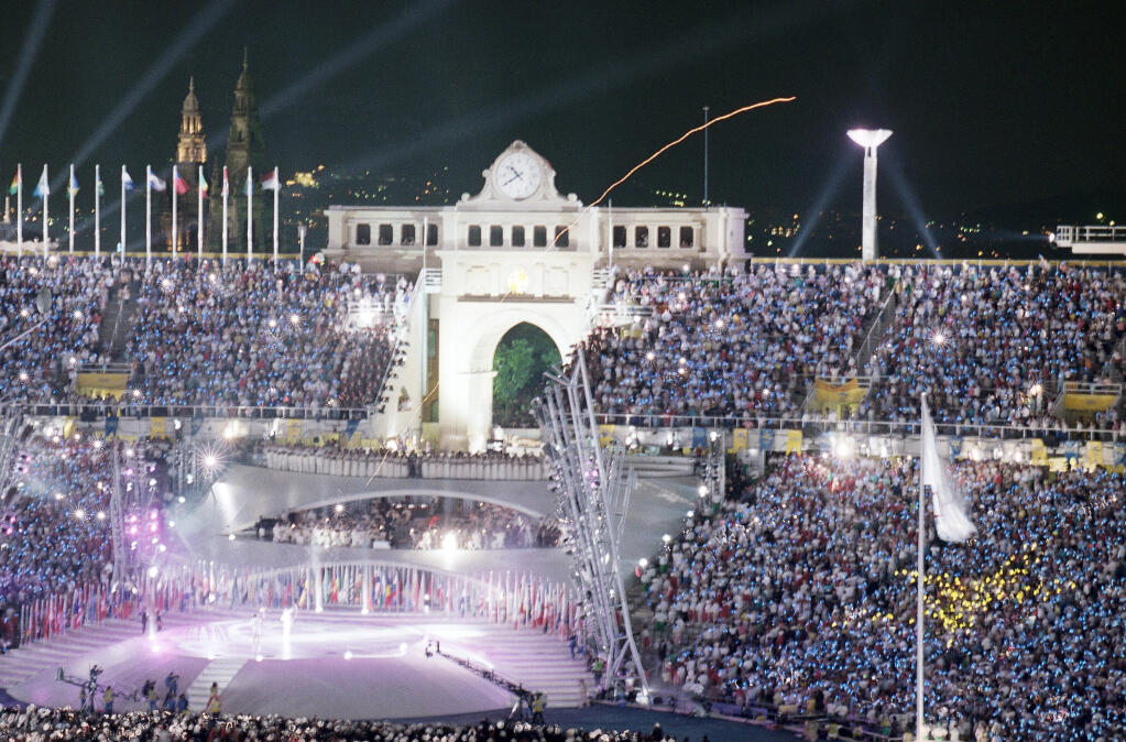 A long exposure shot shows the flight of the flaming arrow as it was shot by Spain?s Antonio Rebollo to light the cauldron with the Olympic Flame during opening ceremonies in Barcelona on Saturday night, July, 25, 1992. (AP Photo/Mark Duncan)