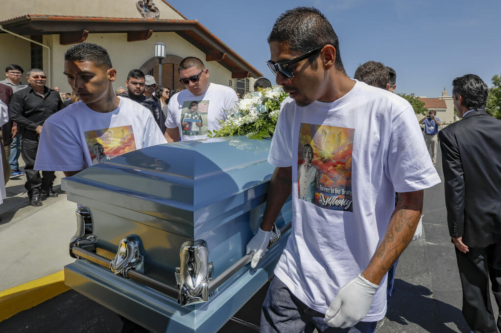 FILE - Victor Avalos, right, father of Anthony Avalos, and other family member carry the casket after a funeral held at Saint Junipero Serra Parish in Quartz Hills, Calif., July 20, 2018. The mother of Avalos, 10 years old, and her boyfriend were each sentenced Tuesday, April 25, 2023, to life in prison for torturing and murdering the child. Heather Barron, 33, and Kareem Leiva, 37, were convicted last month of first-degree murder involving torture. They also were found guilty of child abuse of two other children in their Lancaster home. (Irfan Khan/Los Angeles Times via AP, File)