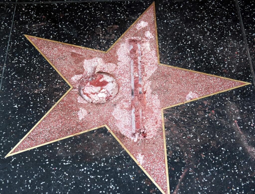 FILE - This Oct. 26, 2016 file photo shows the vandalized Hollywood Walk of Fame star of then-presidential candidate Donald Trump. Authorities say James Lambert Otis, the man who allegedly used a sledgehammer to deface the star of the man who is now president-elect, has been charged with felony vandalism. The Los Angeles County District attorney said the charge was filed Thursday, Nov. 17, 2016. (AP Photo/Richard Vogel, File)