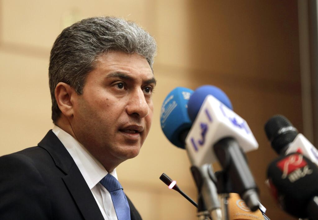 Egyptian Minister of Civil Aviation Sharif Fathy speaks during a press conference at the Ministry headquarters in Cairo, Egypt, Tuesday, March 29, 2016. Fathy said seven people remain with the hijacker on the EgyptAir plane that has landed in Cyprus, four crew and three passengers. (AP Photo/Amr Nabil)
