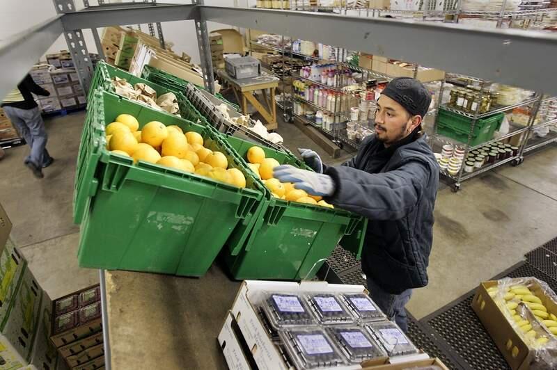 Robbyn Guzman (cq) organizes the placement of produce in the new warehouse facility for Planet Organics in Sonoma on Monday afternoon, June 4, 2007. (The Press Democrat/ Christopher Chung)