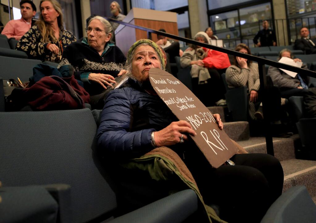 Santa Rosa resident Victoria Yanez of Homeless Action listens along with others as people address Santa Rosa City Council members about the proposed use of the now closed Bennett Valley Senior Center for homeless services, Tuesday, Feb. 12, 2019 in Santa Rosa. (Kent Porter / Press Democrat) 2019