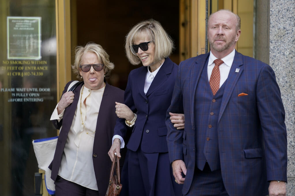 Former advice columnist E. Jean Carroll, center, leaves federal court after testifying in her rape trial against former President Donald Trump, Wednesday April 26, 2023, in New York. (AP Photo/John Minchillo)