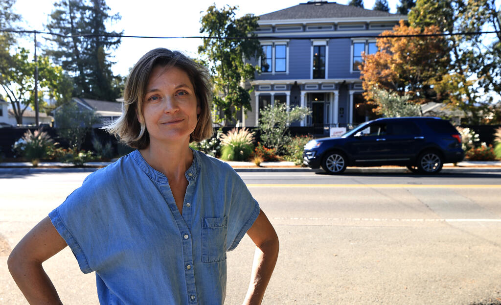 Maya Elmer, who lives in the area of The Ruse, formerly the Honor Mansion, background, is opposed to the owners operating the property as a private club along Grove Street in Healdsburg, Tuesday, Oct. 19, 2022. (Kent Porter / The Press Democrat)