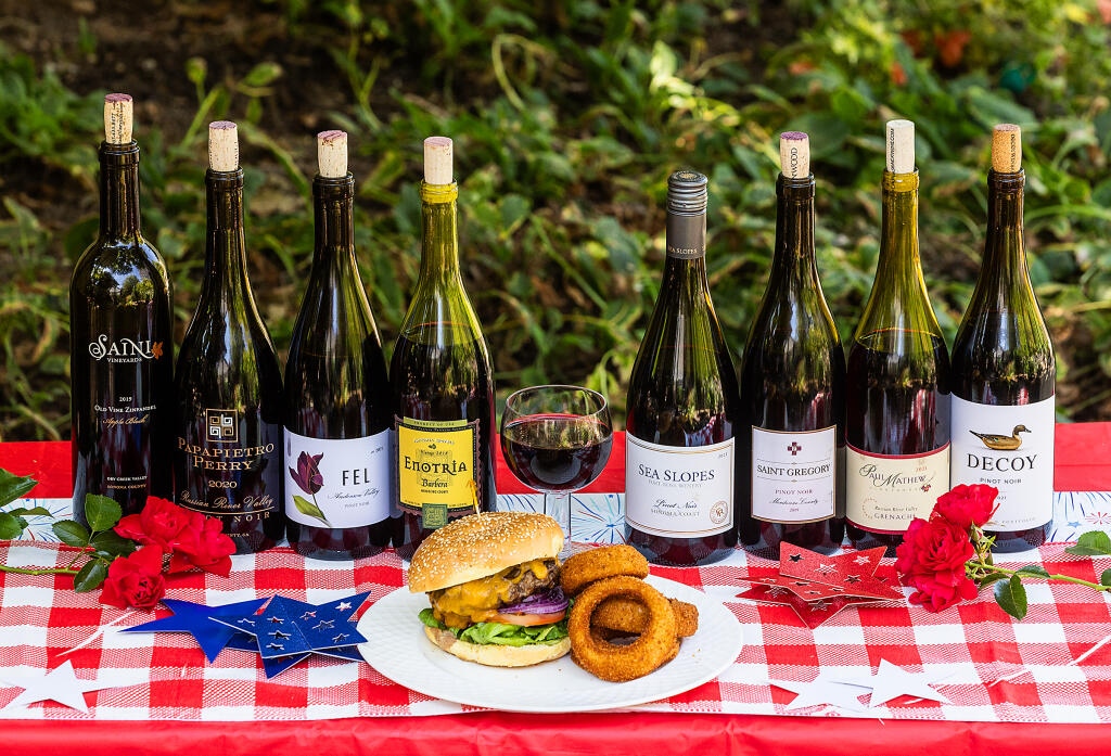 First place winner Enotria, 2018 Barbera, Mendocino County and the seven other wines in this year’s Press Democrat Hamburger Red tasting with a Phyllis’ Giant Mushroom Cheddar Burger with a side of onion rings. Photo taken  Monday, June 26, 2023. (John Burgess / The Press Democrat)