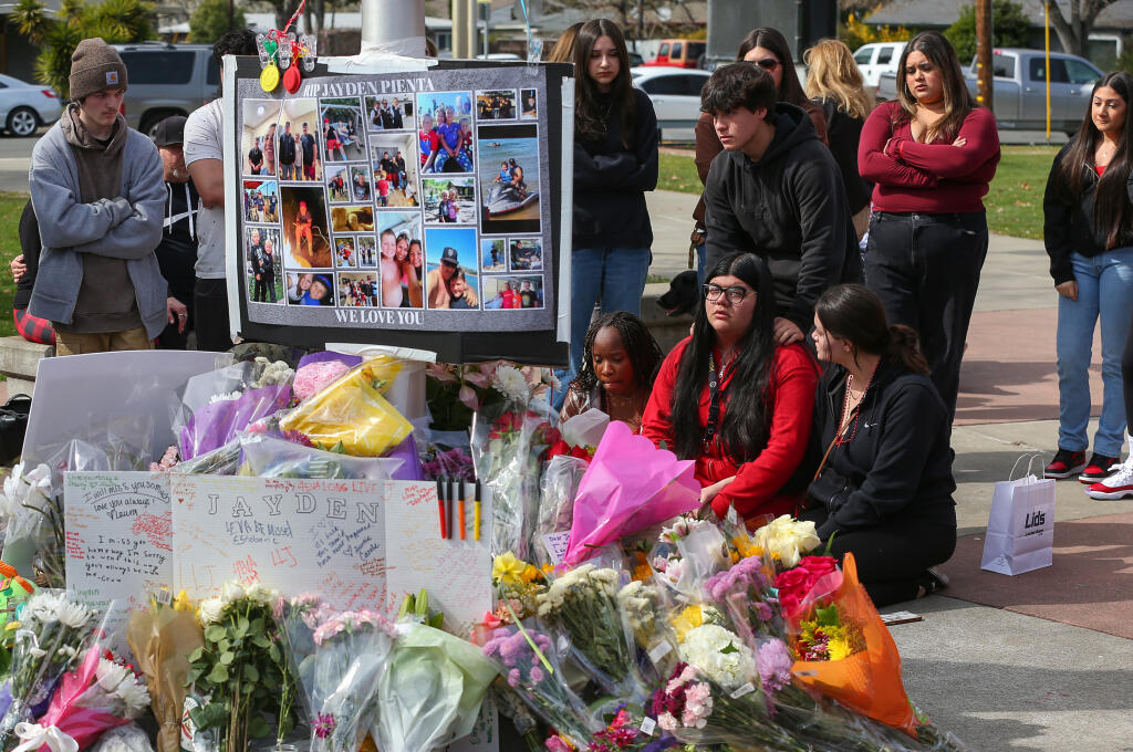 Marco Bautista, standing, joins Jean Maina, seated left, Olivia Cruz, Mariana Mitchell and other classmates in mourning the loss of Jayden Pienta at Montgomery High School in Santa Rosa, Friday, March 3, 2023. (Christopher Chung / The Press Democrat file)