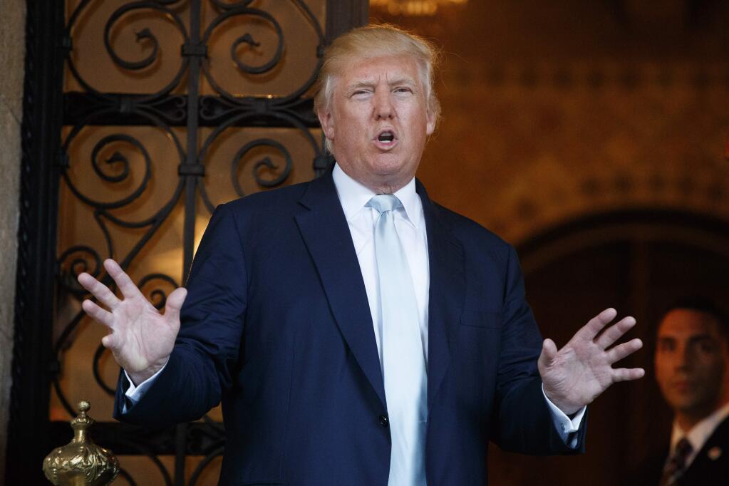 FILE - In this Wednesday, Dec. 28, 2016, file photo, President-elect Donald Trump speaks to reporters at Mar-a-Lago in Palm Beach, Fla. (AP Photo/Evan Vucci, File)
