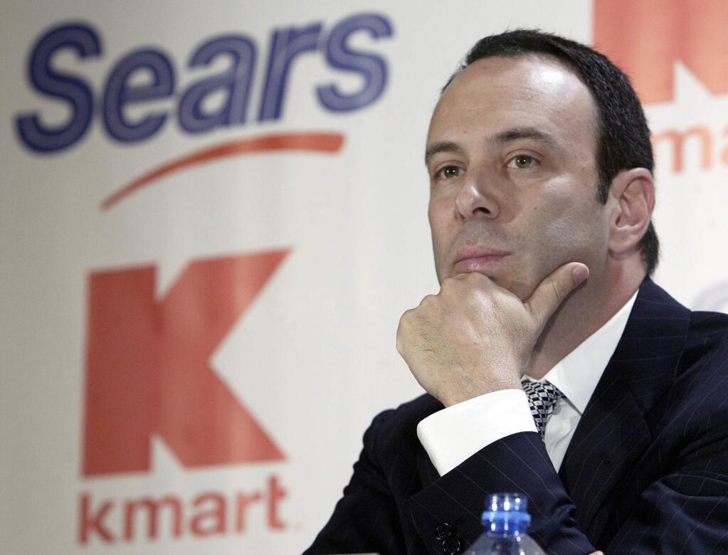 FILE- In this Nov. 17, 2004, file photo Kmart chairman Edward Lampert listens during a news conference to announce the merger of Kmart and Sears in New York. As Sears teeters on the brink of collapse, there's one man at the center of the fight for the future of the iconic retailer. Lampert plays several, often conflicting, roles in what could be the final chapter for the company that began as a mail order watch business 132 years ago. He's been chairman, CEO, landlord, lender, and largest shareholder all at the same time. If the company survives, he wins. If it ends up liquidating, he also wins. (AP Photo/Gregory Bull, File)