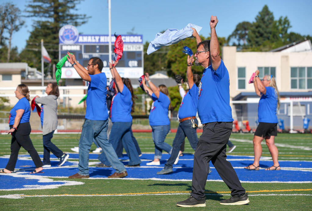 New principal Chuck Wade performs a welcome dance with other faculty members during an assembly at Analy High School in Sebastopol, Wednesday, Aug. 16, 2023. (Christopher Chung / The Press Democrat)