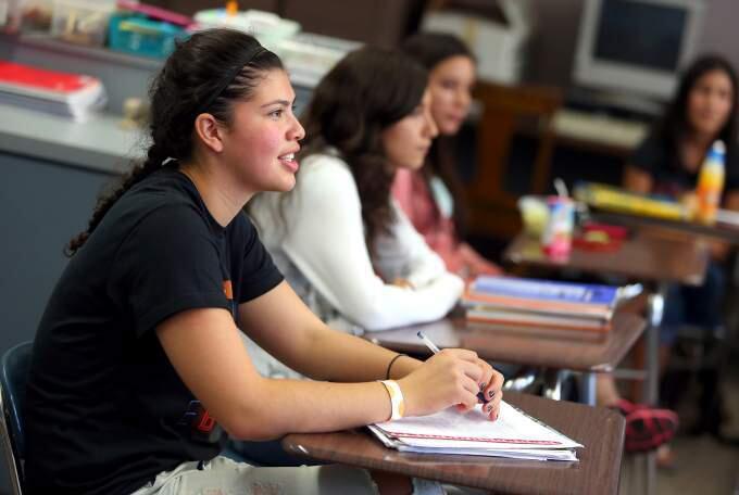 Maria Salcido, Analy's Latino Student Congress representative, listens to Karym Sanchez talk about the importance of getting people to vote during a MECHA meeting at Analy High School, in Sebastopol on Thursday, Oct. 2, 2014. (Christopher Chung/ The Press Democrat)