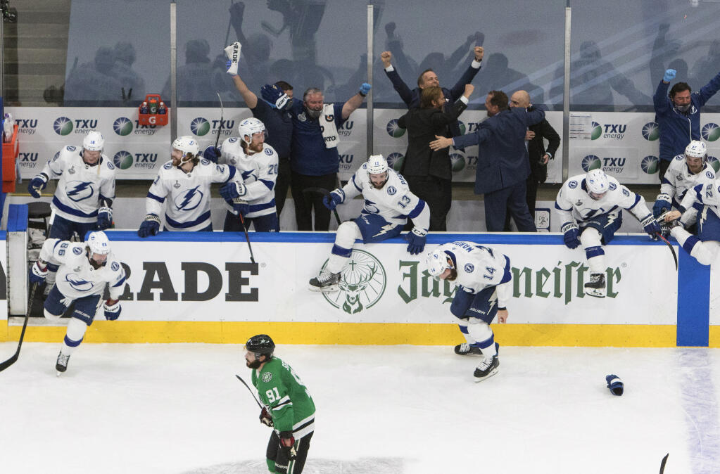 Tampa Bay Lightning players celebrate after defeating the Dallas Stars to win the Stanley Cup in Edmonton, Alberta, on Monday, Sept. 28, 2020. (Jason Franson/The Canadian Press via AP)