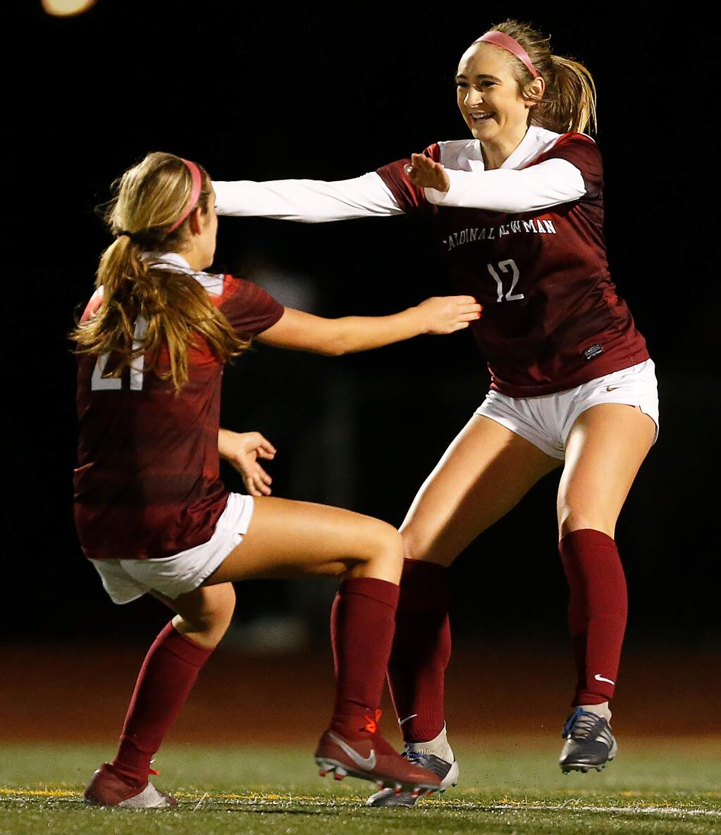 Cardinal Newman's Ella Wright, right, embraces teammate Keely Roy after Wright scored the Cardinals' first goal during the first half of the NCS Division IV girls varsity soccer final match between Marin Academy and Cardinal Newman high schools, in Santa Rosa, California, on Saturday, February 23, 2019. (Alvin Jornada / The Press Democrat)