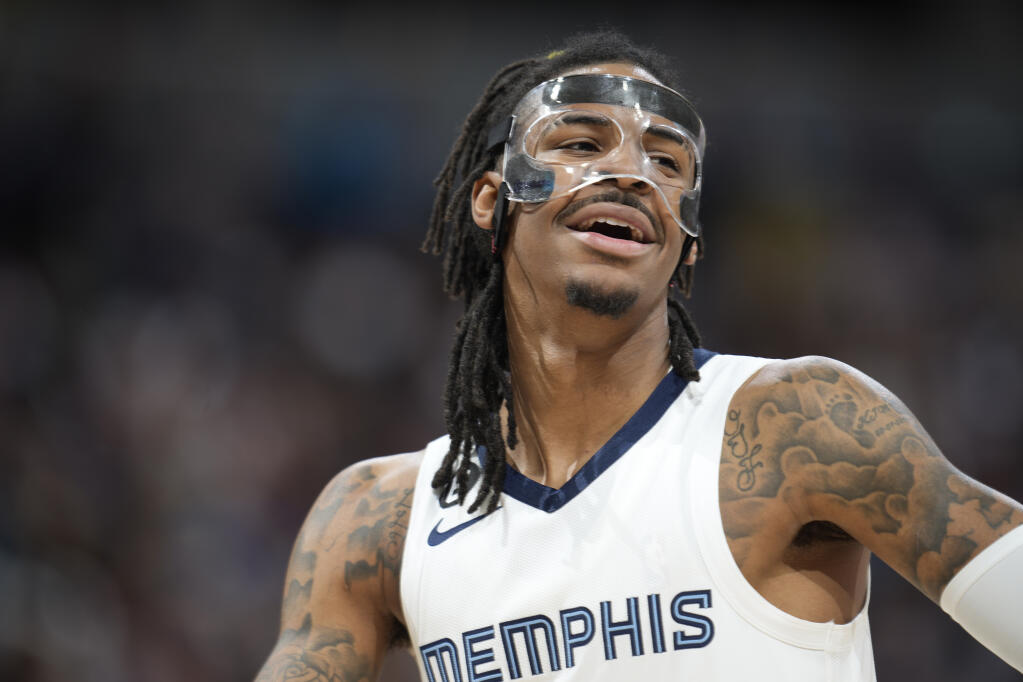 Memphis Grizzlies guard Ja Morant looks to the bench during the second half of the team's NBA basketball game against the Denver Nuggets on Friday, March 3, 2023, in Denver. (AP Photo/David Zalubowski)