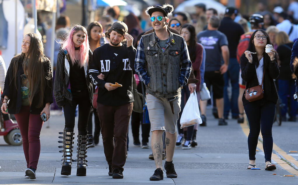 People walk Fourth Street in 2018 as the Wednesday Night Market returns to downtown Santa Rosa.  (Kent Porter / The Press Democrat file)