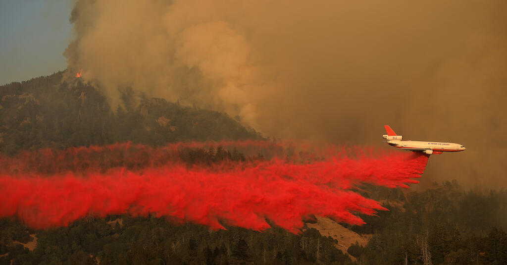 A blow up in the Palisades above Calistoga prompted a response from aircraft, Wednesday, Sept. 30, 2020 as a retardant line is put down between Highway 29 over Mt. St. Helena and the Glass fire flames.  (Kent Porter / The Press Democrat) 2020
